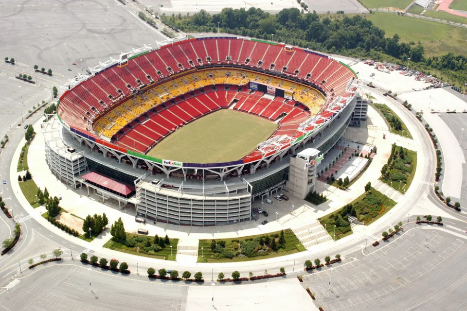 A aerial view of an empty FedEx Field, home of the NFL's Washington Commanders, and parking lot.